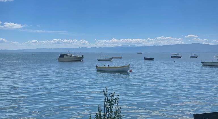 Small boats on the calm, clear water of Lake Ohrid